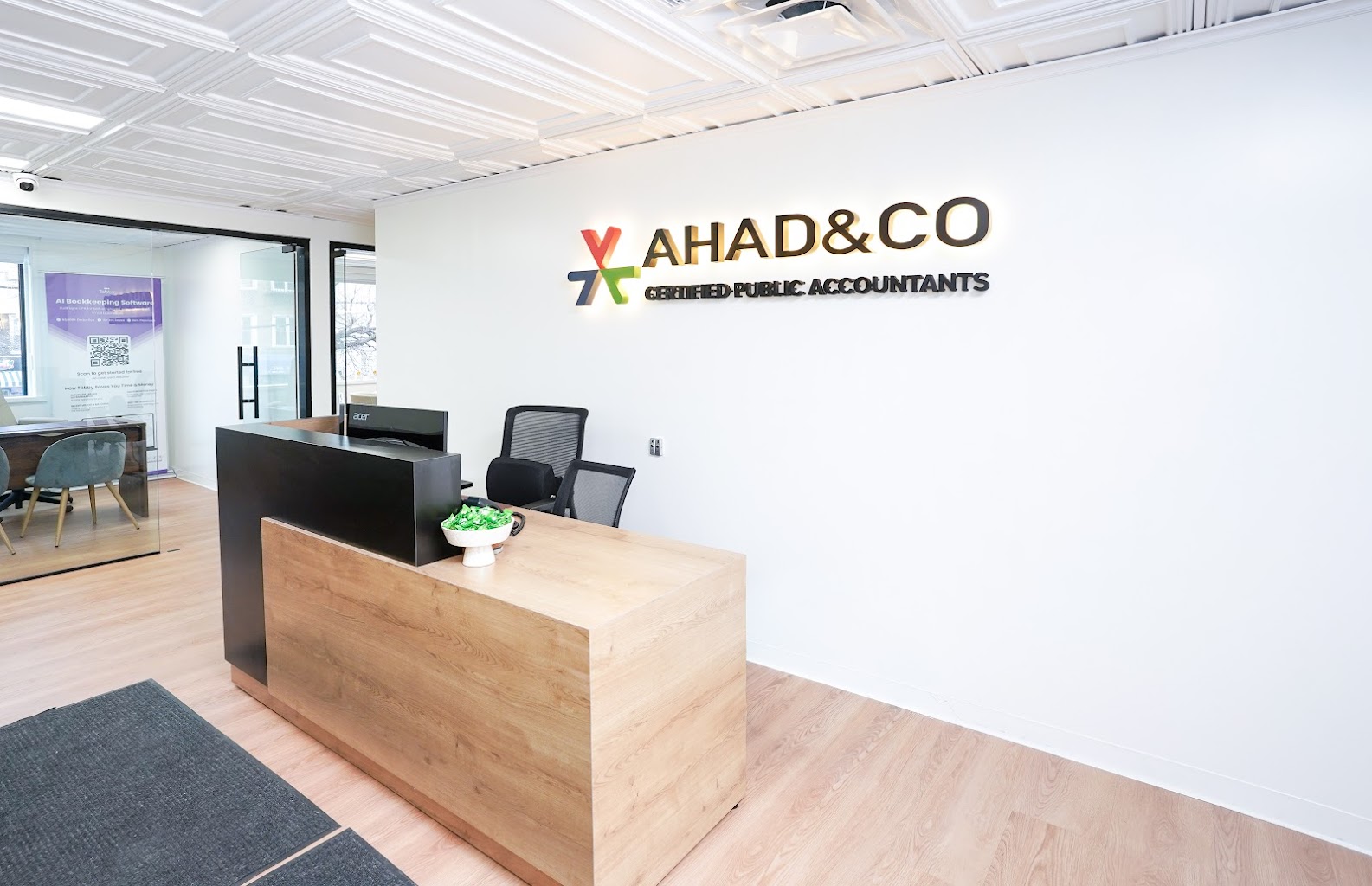 Ahad & Co Certified Public Accountants reception area with branded wall signage in the Bronx