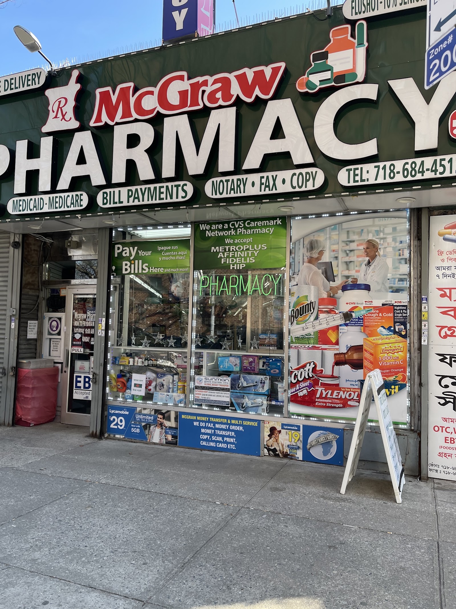 McGraw Pharmacy storefront with full signage showing Medicaid, Medicare, Bill Payments, Notary services and Bengali text on McGraw Avenue, Parkchester, Bronx
