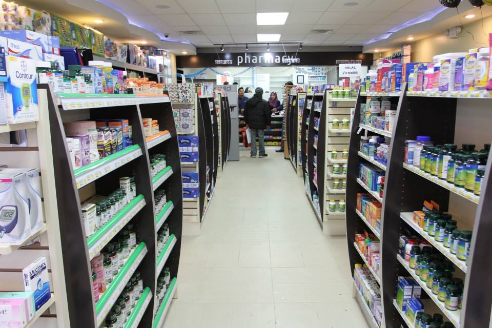 Starling Pharmacy interior showing well-stocked aisles, pharmacy counter, and Halal Vitamins section in Parkchester, Bronx