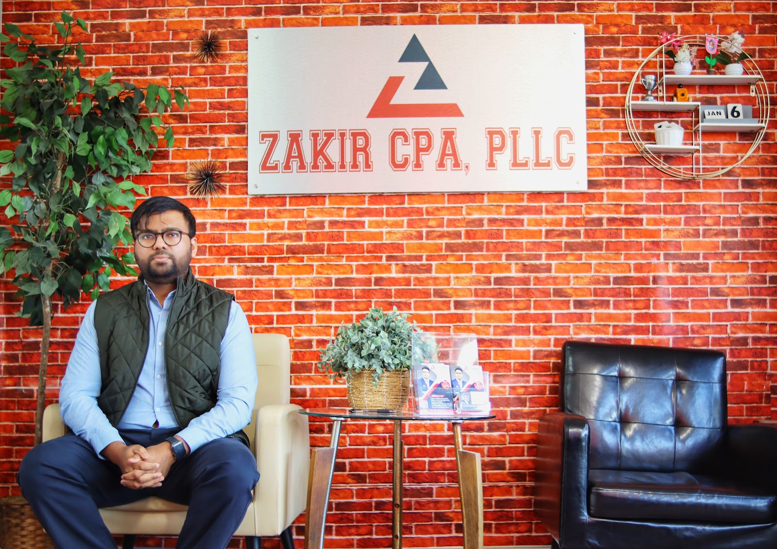 Zakir CPA PLLC office interior with branded signage on brick wall, Westchester Avenue, Bronx
